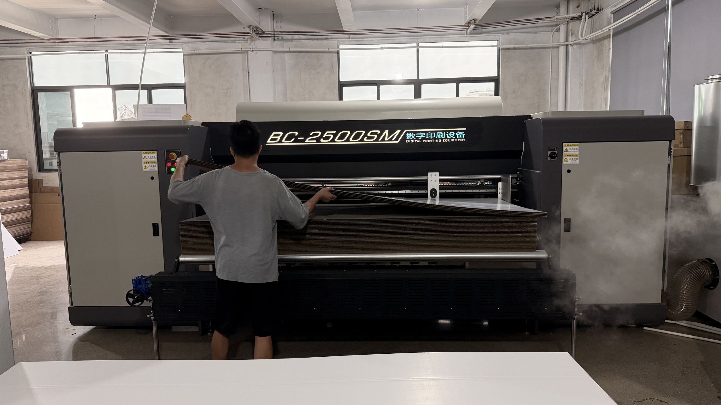 TYCHEN BC-2500SM Scanning Digital Printer being loaded with corrugated board